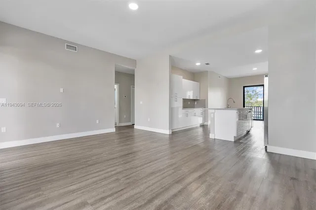a view of a room with wooden floor and a window