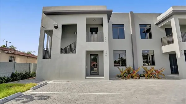 a view of a house with more windows and a yard