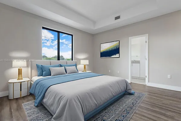 a bedroom with a large bed and a window