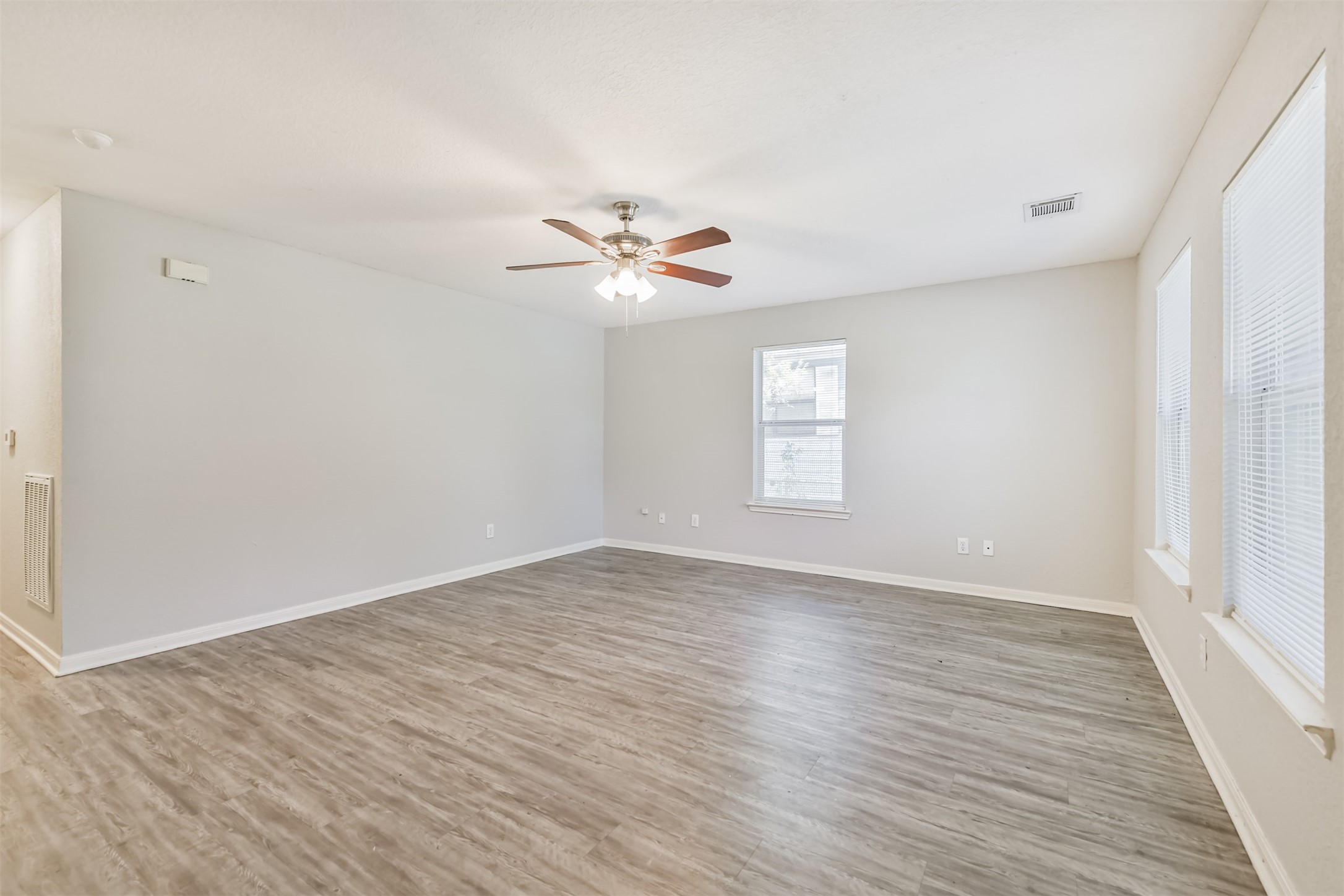 617 Avenue I Conroe, TX 77301 - Photo 5 of 19 Large bright living room with LVP flooring and ceiling fan