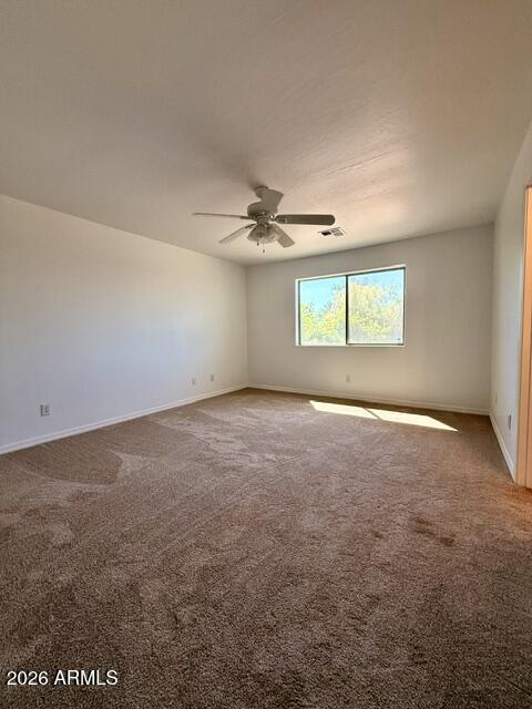3527 East Batten Road Eloy, AZ 85131 - Photo 4 of 10 an empty room with a ceiling fan and window