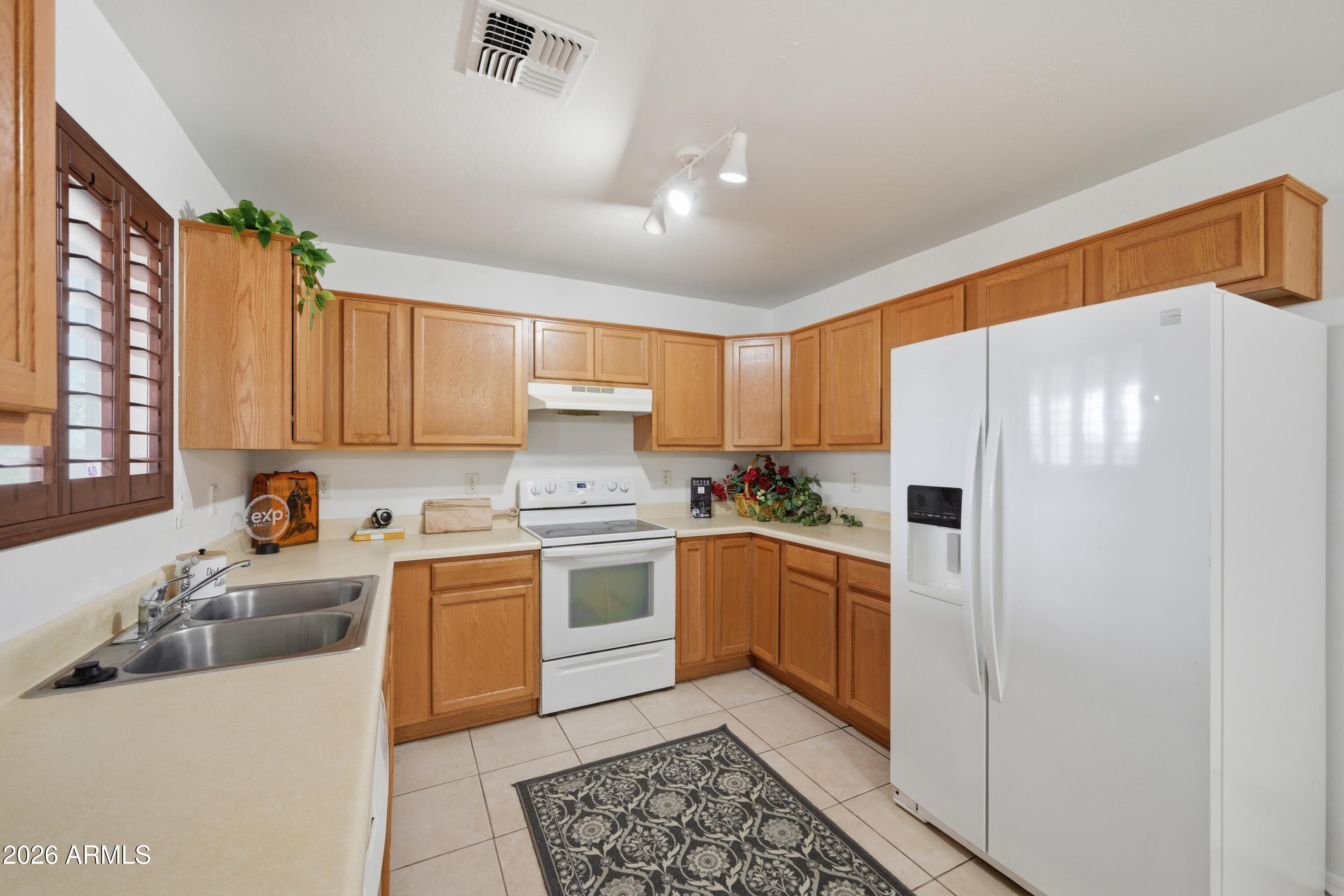 3527 East Batten Road Eloy, AZ 85131 - Photo 5 of 17 a kitchen with a sink a stove a refrigerator and cabinets