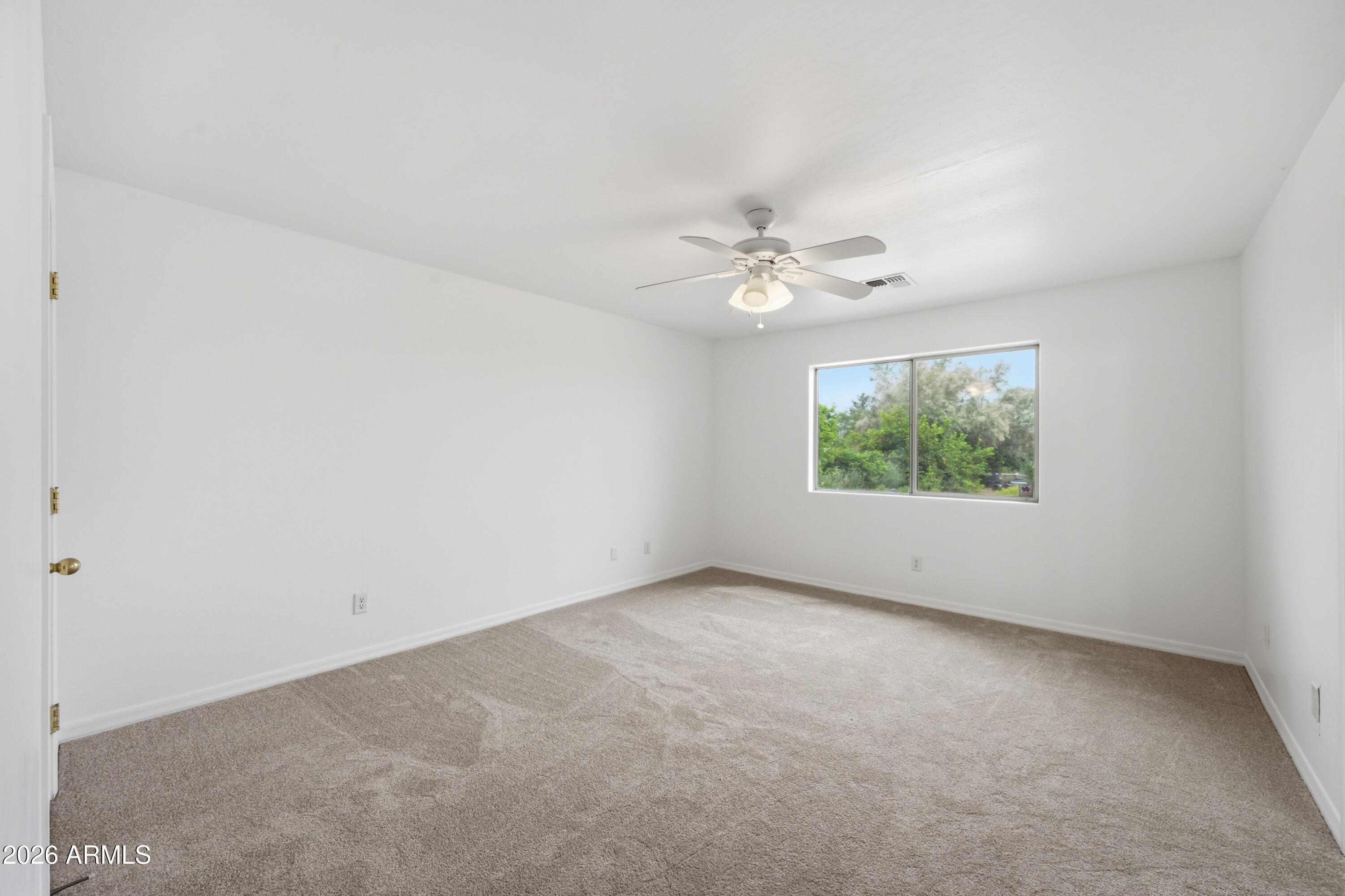 3527 East Batten Road Eloy, AZ 85131 - Photo 7 of 17 an empty room with a window
