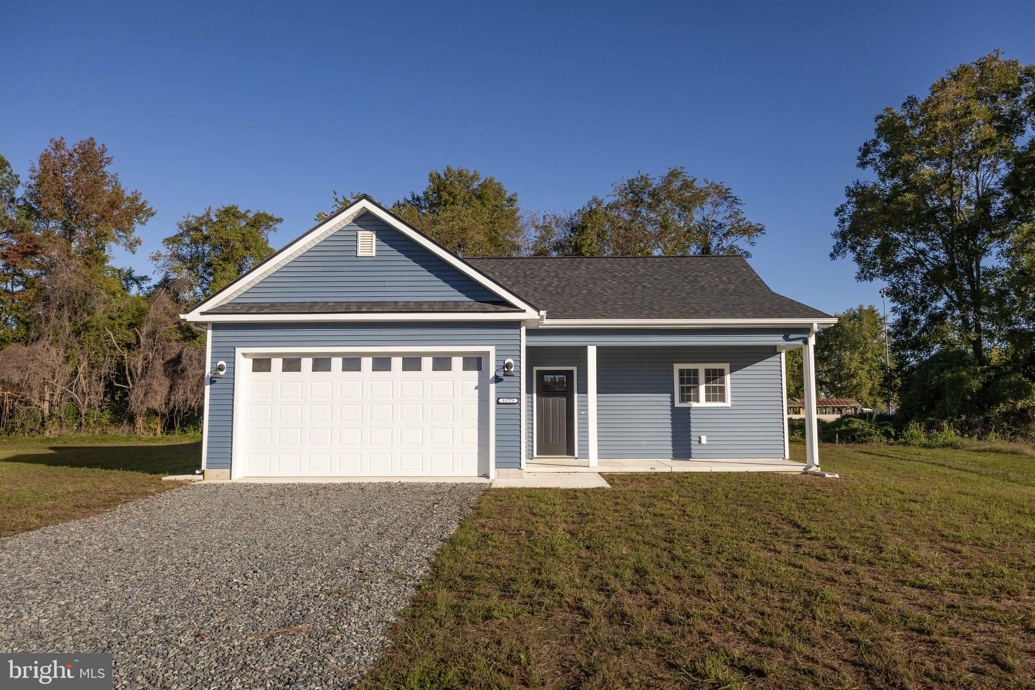 11775 St Stephens Way Princess Anne, MD 21853 - Photo 1 of 51 a front view of a house with a yard and garage