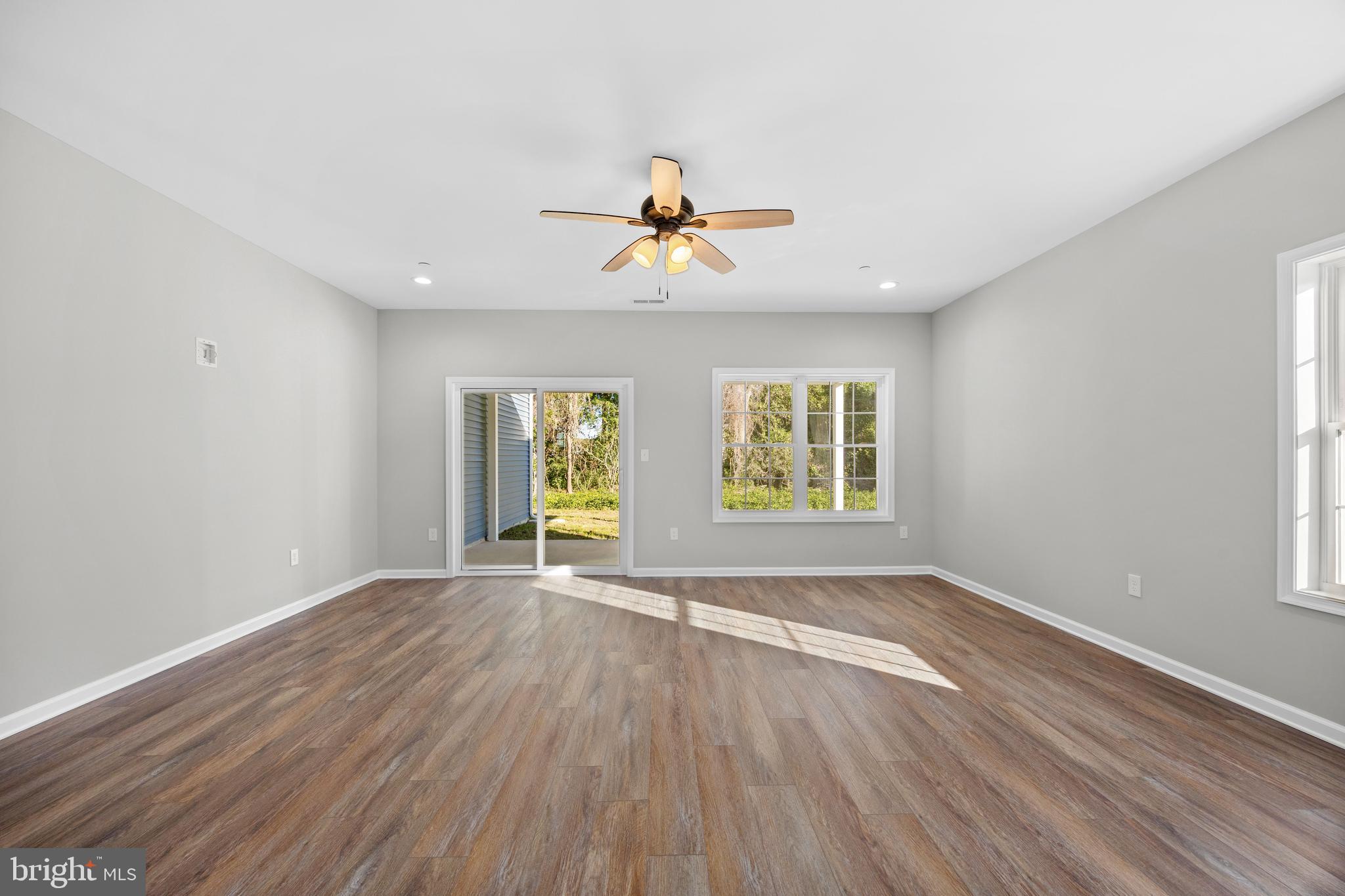 11775 St Stephens Way Princess Anne, MD 21853 - Photo 13 of 51 an empty room with windows and chandelier fan