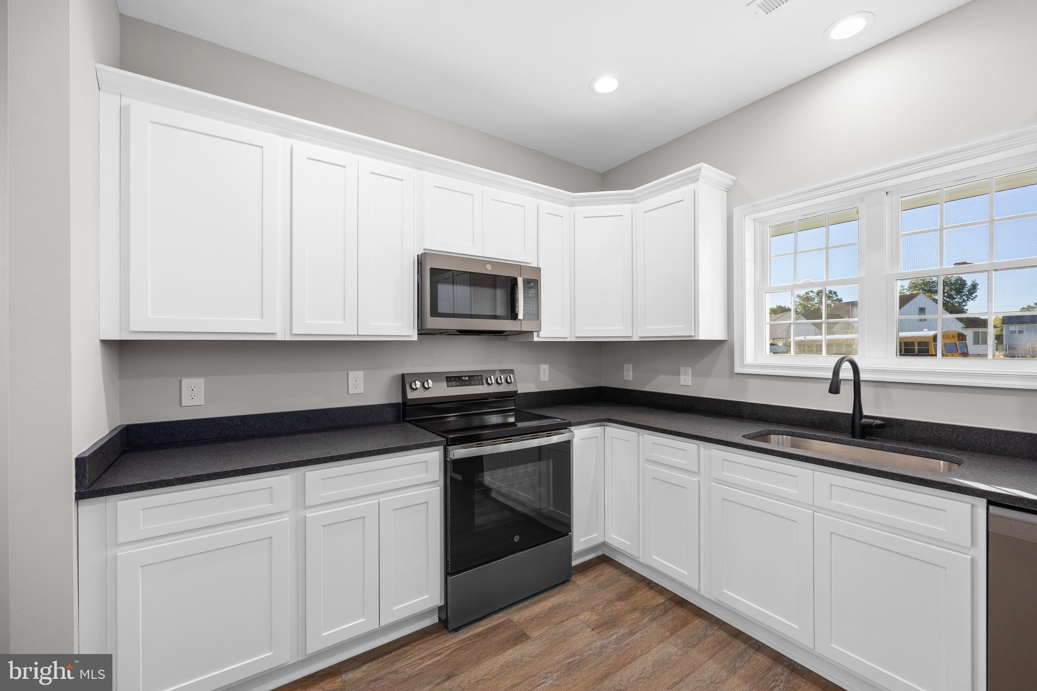 11775 St Stephens Way Princess Anne, MD 21853 - Photo 14 of 51 a white kitchen with granite countertop white cabinets and a granite counter tops