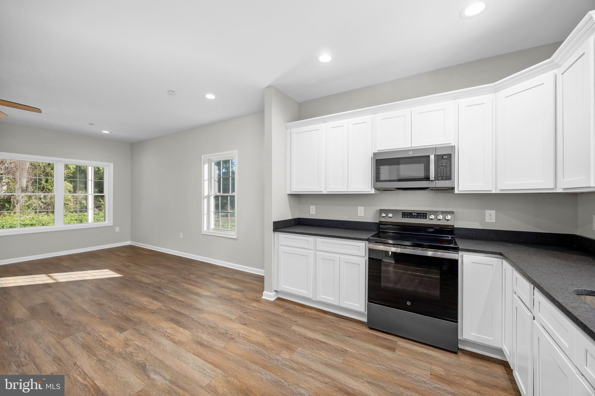 11775 St Stephens Way Princess Anne, MD 21853 - Photo 18 of 51 a kitchen with stainless steel appliances granite countertop a stove a sink and a microwave