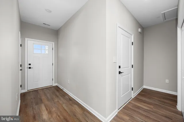 an empty room with a window and ceiling fan
