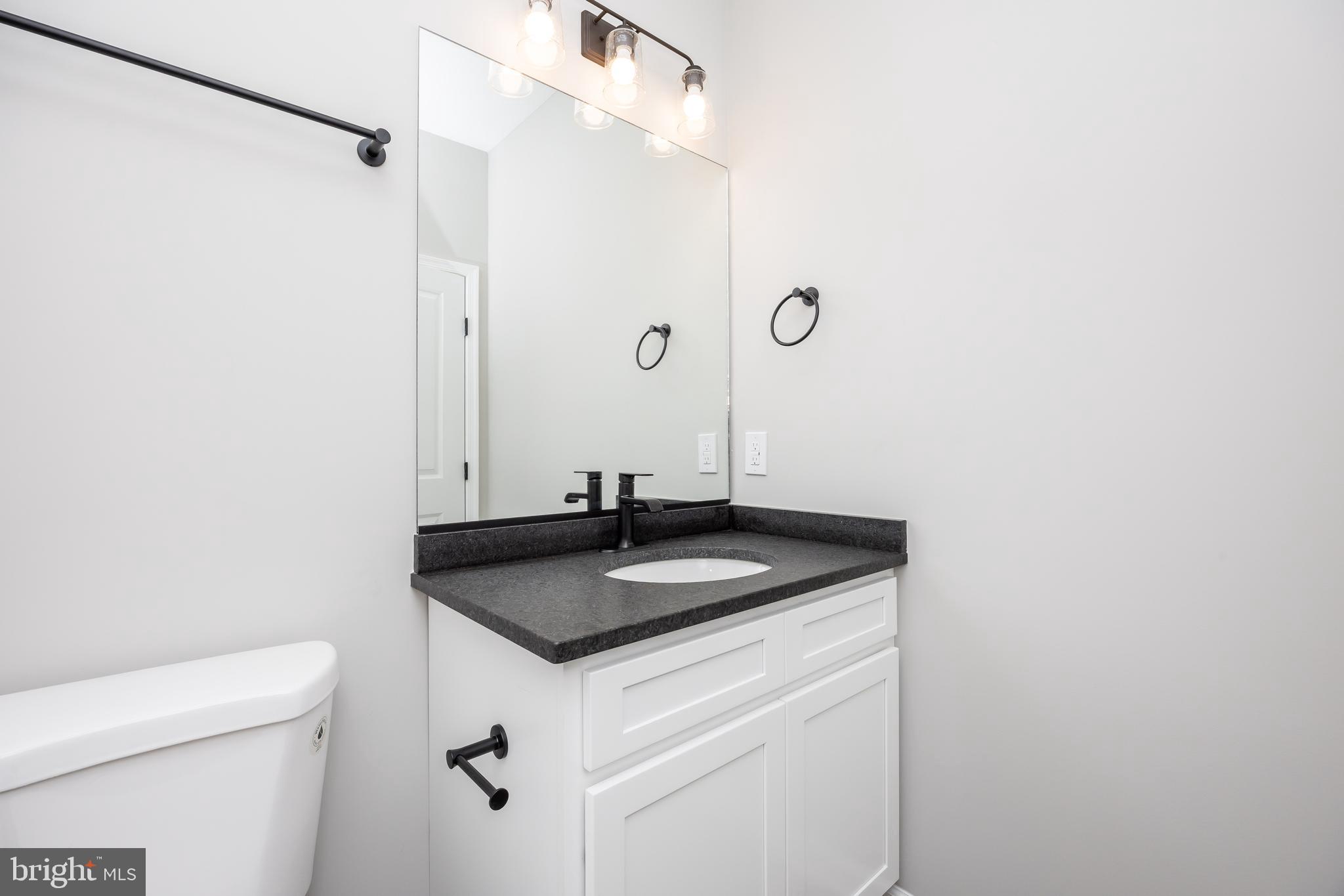 11775 St Stephens Way Princess Anne, MD 21853 - Photo 26 of 51 a bathroom with a granite countertop sink and a mirror