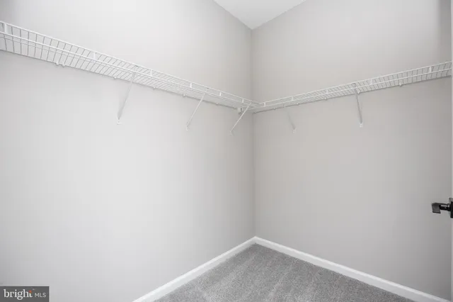 a bathroom with a granite countertop toilet sink and mirror