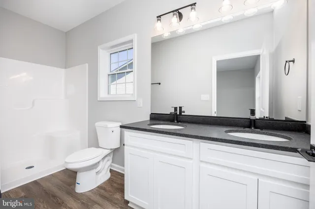 a white toilet sitting next to a bathroom sink