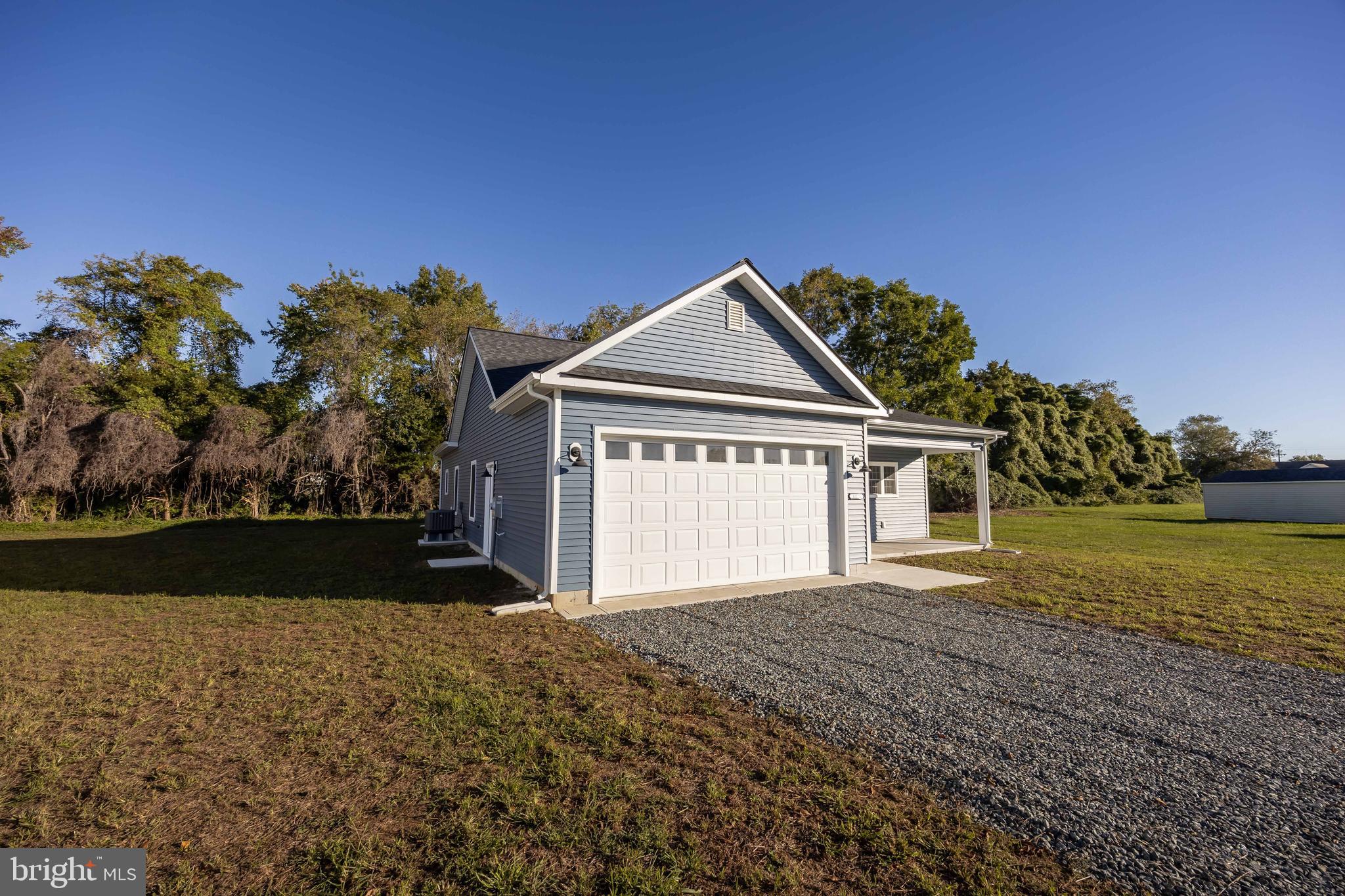 11775 St Stephens Way Princess Anne, MD 21853 - Photo 4 of 51 a front view of a house with a yard and garage