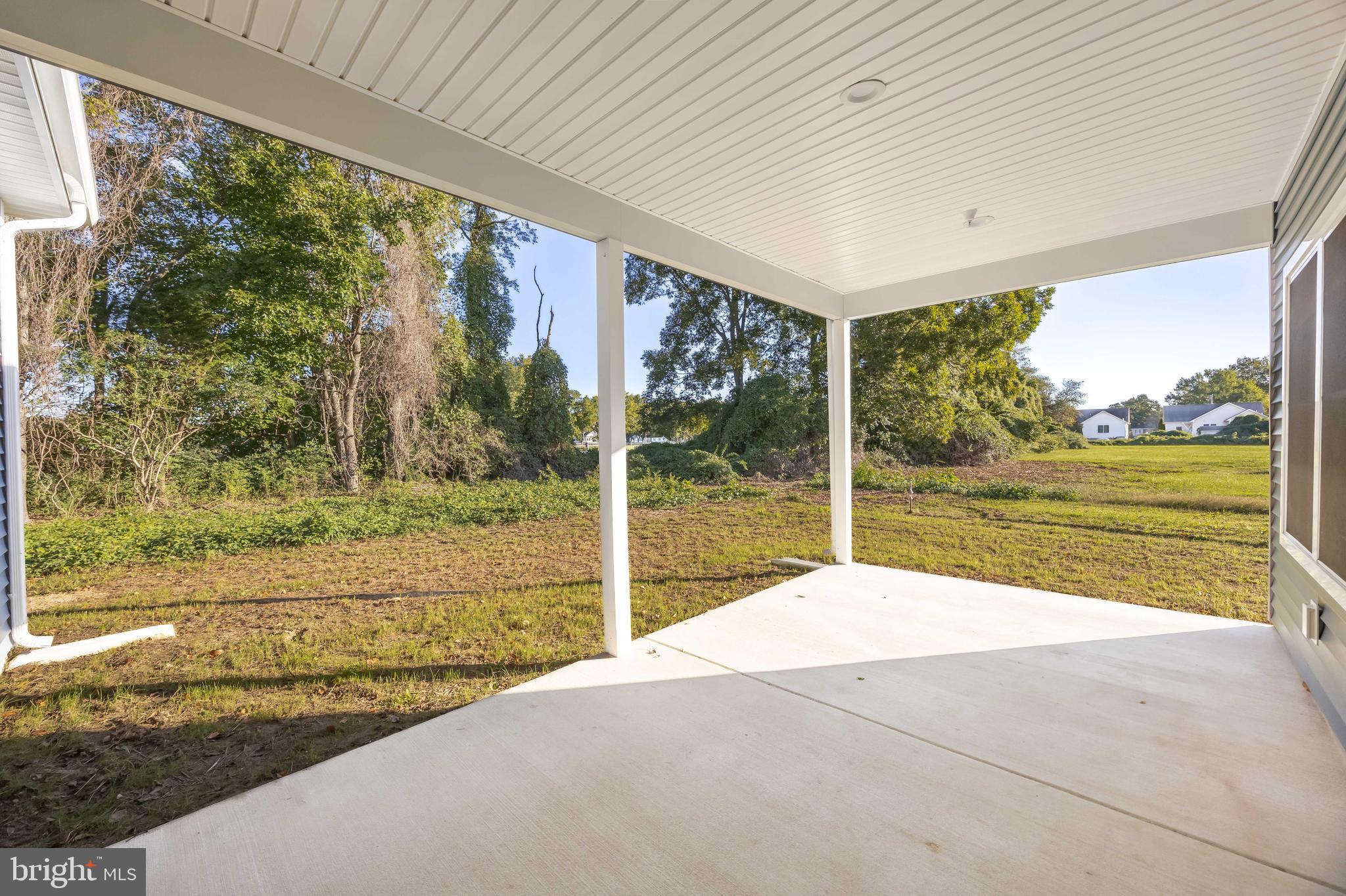 11775 St Stephens Way Princess Anne, MD 21853 - Photo 43 of 51 a view of swimming pool with large windows and trees