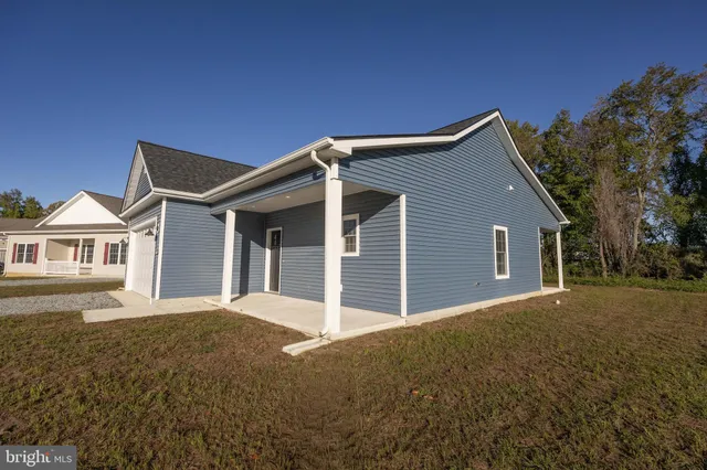 a view of an empty room with a window and a ceiling fan