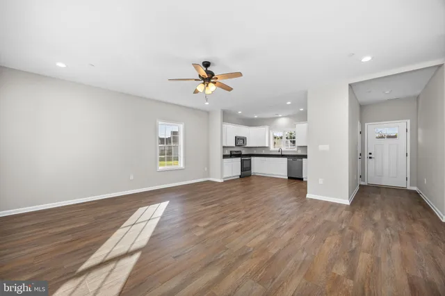 a view of a kitchen with a sink and a refrigerator