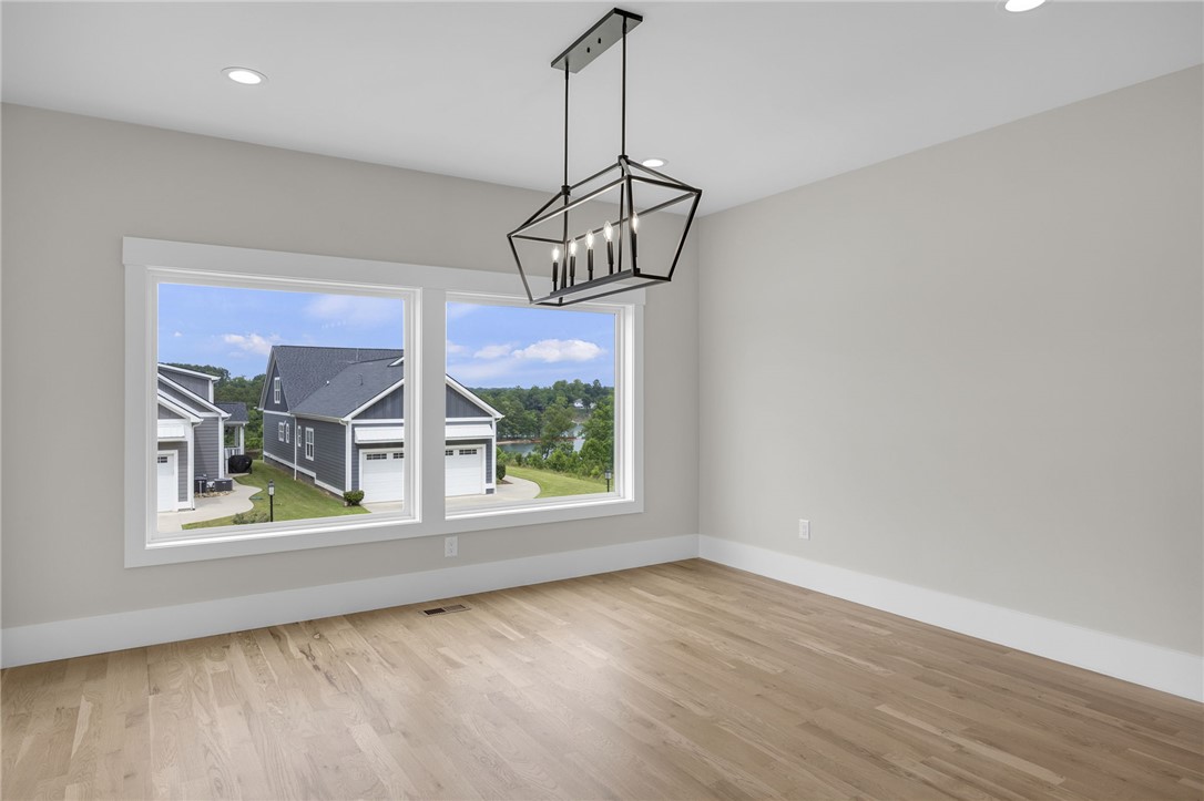 1230 Melton Road, Unit 216 West Union, SC 29696 - Photo 4 of 49 A striking modern chandelier illuminates this naturally lit room with hardwood floors.