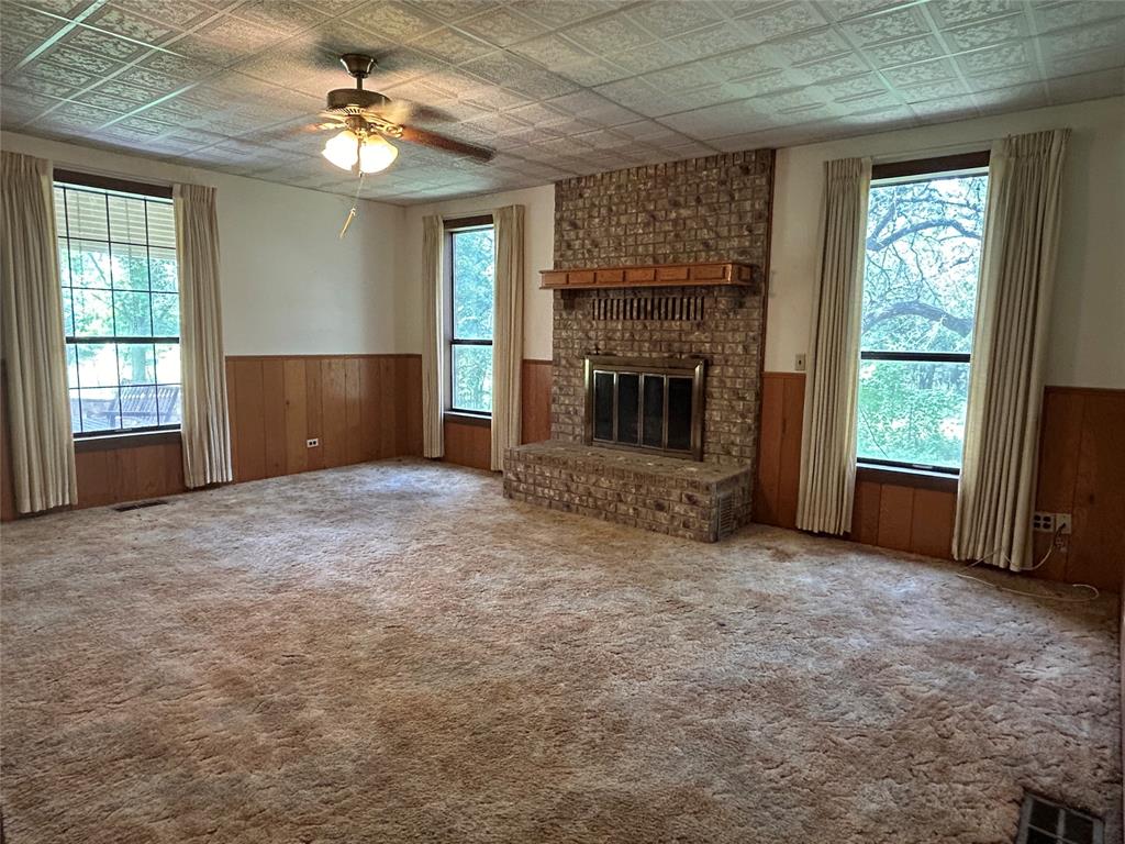 341 West Fm 574 Goldthwaite, TX 76844 - Photo 22 of 40 an empty room with windows and fireplace
