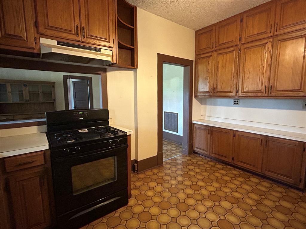 341 West Fm 574 Goldthwaite, TX 76844 - Photo 25 of 40 a kitchen with stainless steel appliances granite countertop a stove a refrigerator and a microwave