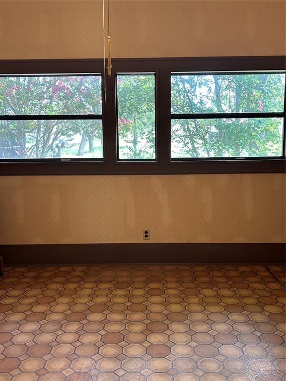 341 West Fm 574 Goldthwaite, TX 76844 - Photo 27 of 40 a view of empty room with wooden floor and a floor to ceiling window