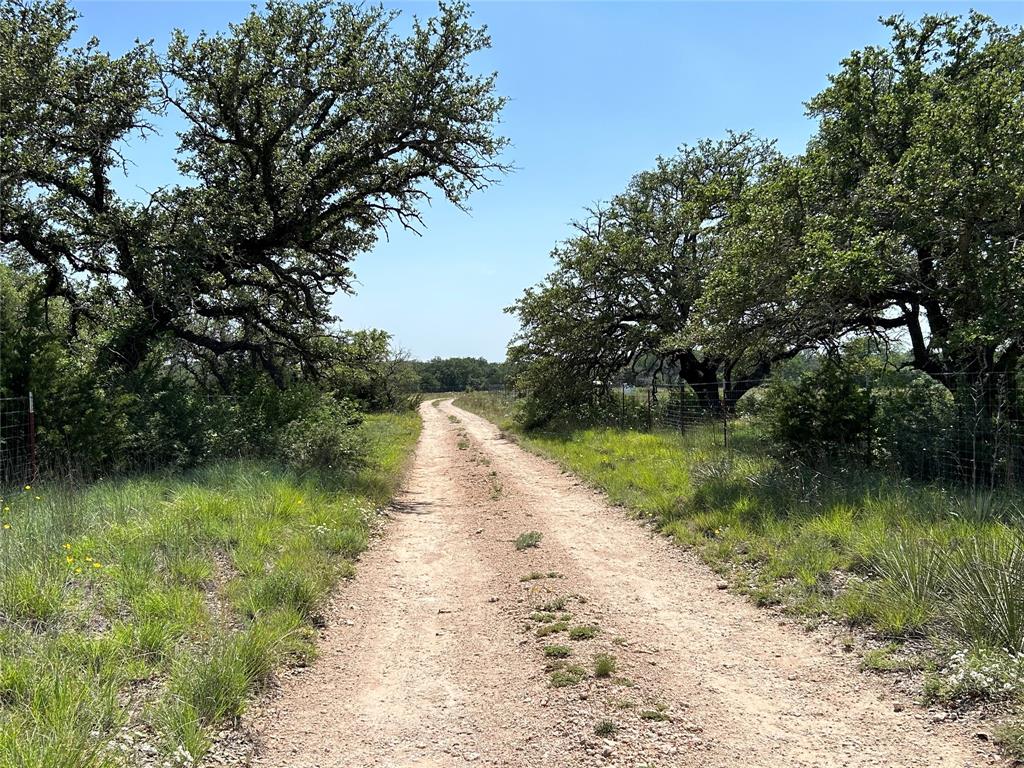 341 West Fm 574 Goldthwaite, TX 76844 - Photo 5 of 40 a view of a lake with a yard and large trees