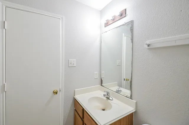 a bathroom with a sink a mirror and shower