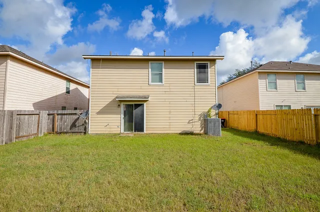 a view of a house with a yard and garage