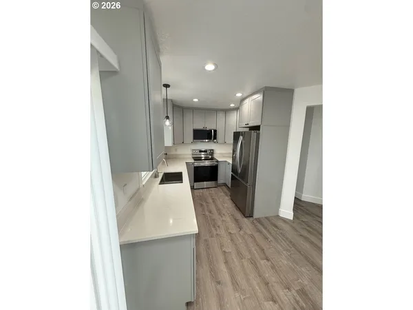 a kitchen with a refrigerator and a sink