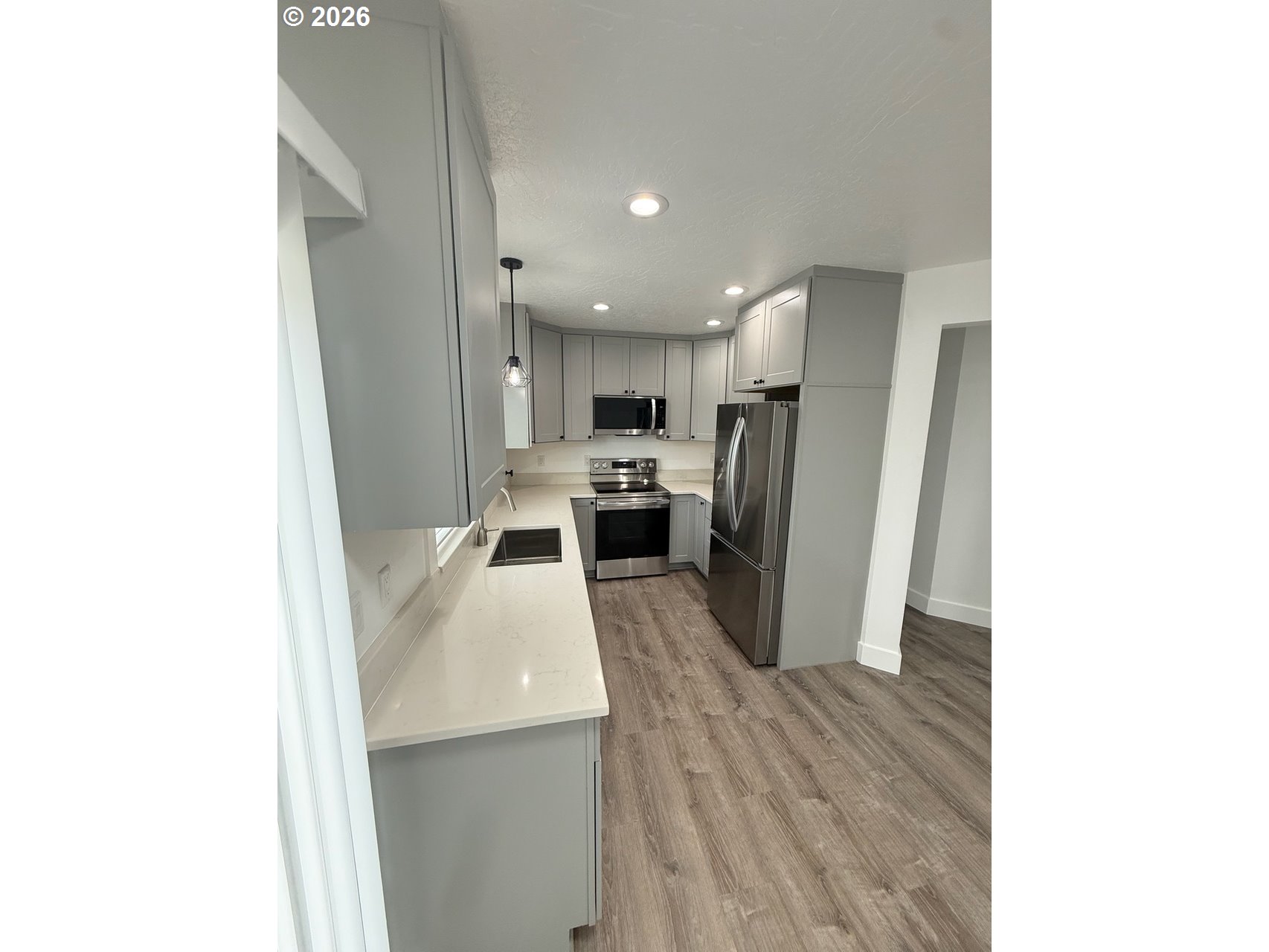 905 Monroe Street Harrisburg, OR 97446 - Photo 11 of 31 a kitchen with a refrigerator and a sink