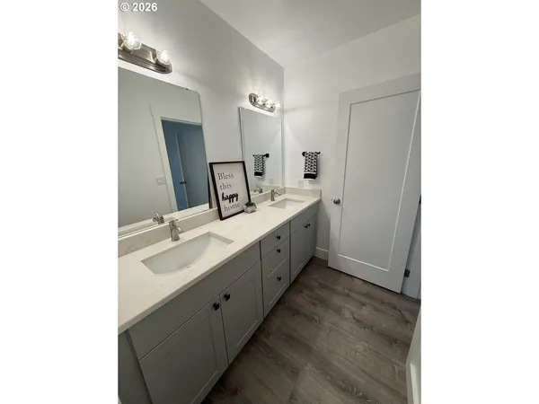 a spacious bathroom with double vanity and mirrors