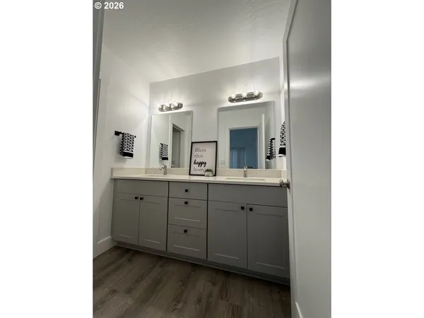 a spacious bathroom with a double vanity sink and mirror