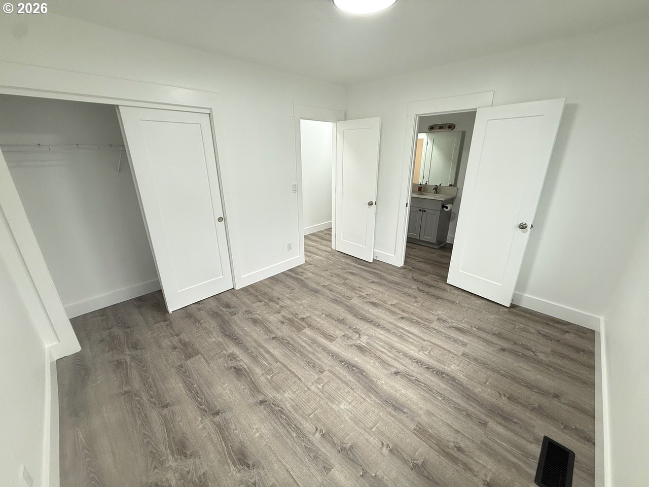 905 Monroe Street Harrisburg, OR 97446 - Photo 20 of 31 an empty room with wooden floor and a fireplace