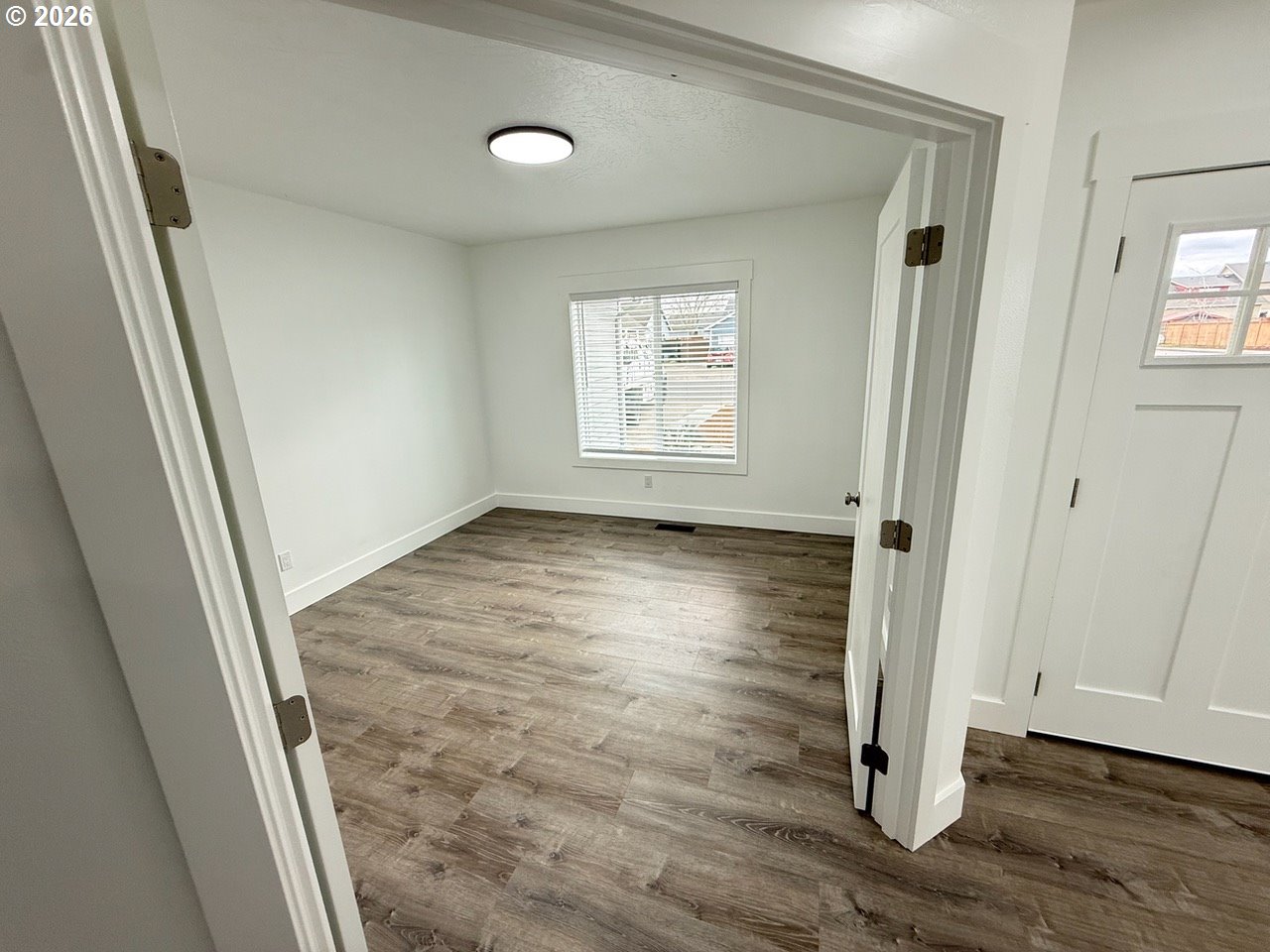 905 Monroe Street Harrisburg, OR 97446 - Photo 25 of 31 an empty room with wooden floor and windows