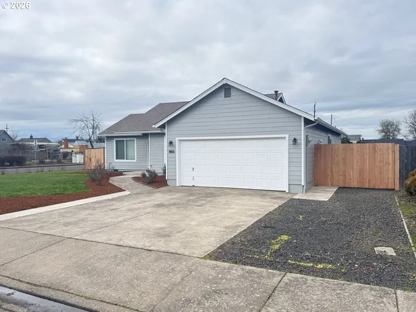 a view of a house with a yard and fence
