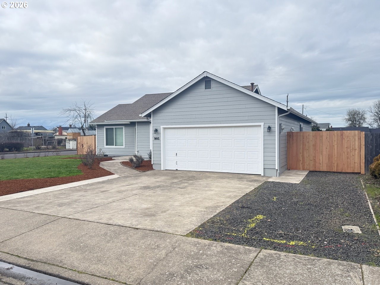 905 Monroe Street Harrisburg, OR 97446 - Photo 3 of 31 a view of a house with a yard and fence