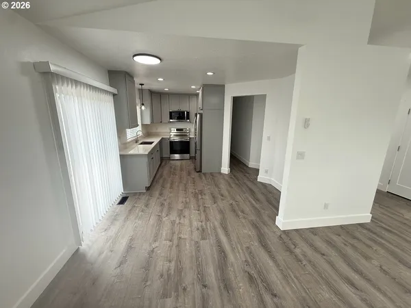 a view of a kitchen from a hallway