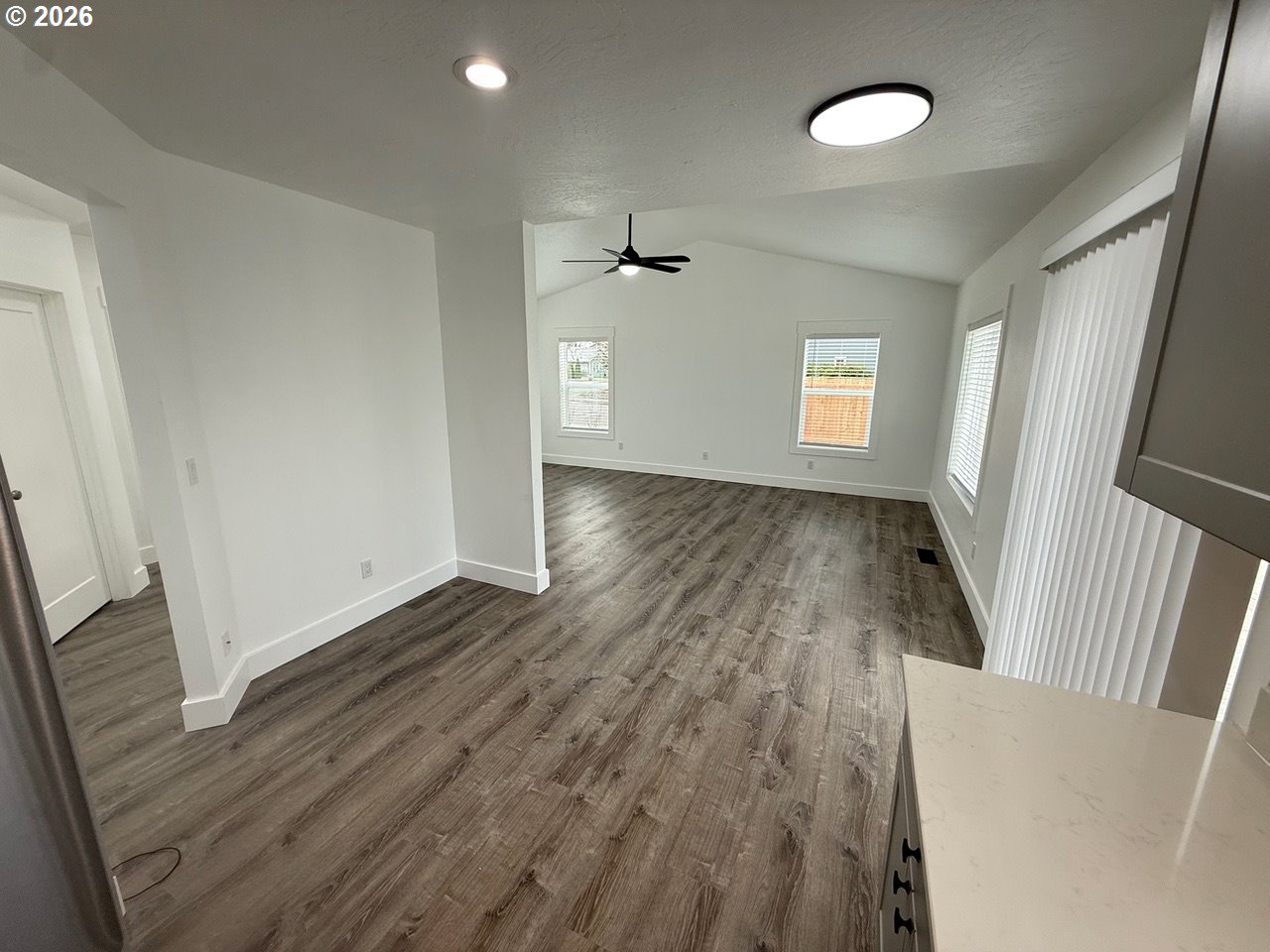 905 Monroe Street Harrisburg, OR 97446 - Photo 10 of 31 an empty room with wooden floor and windows