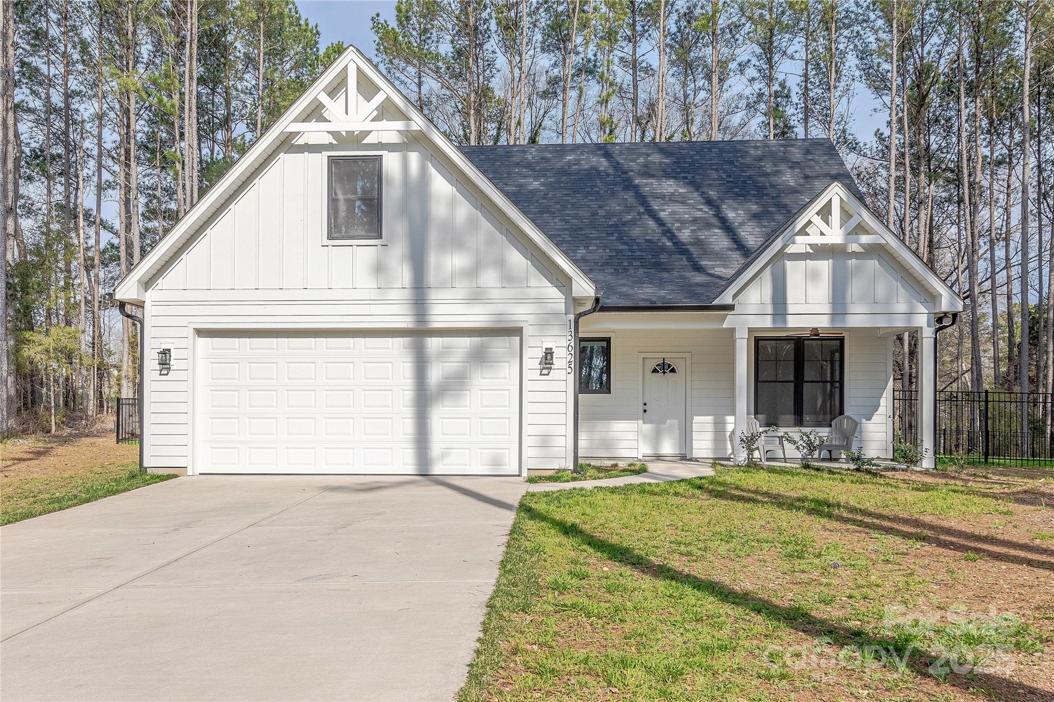 a front view of a house with yard outdoor seating and garage