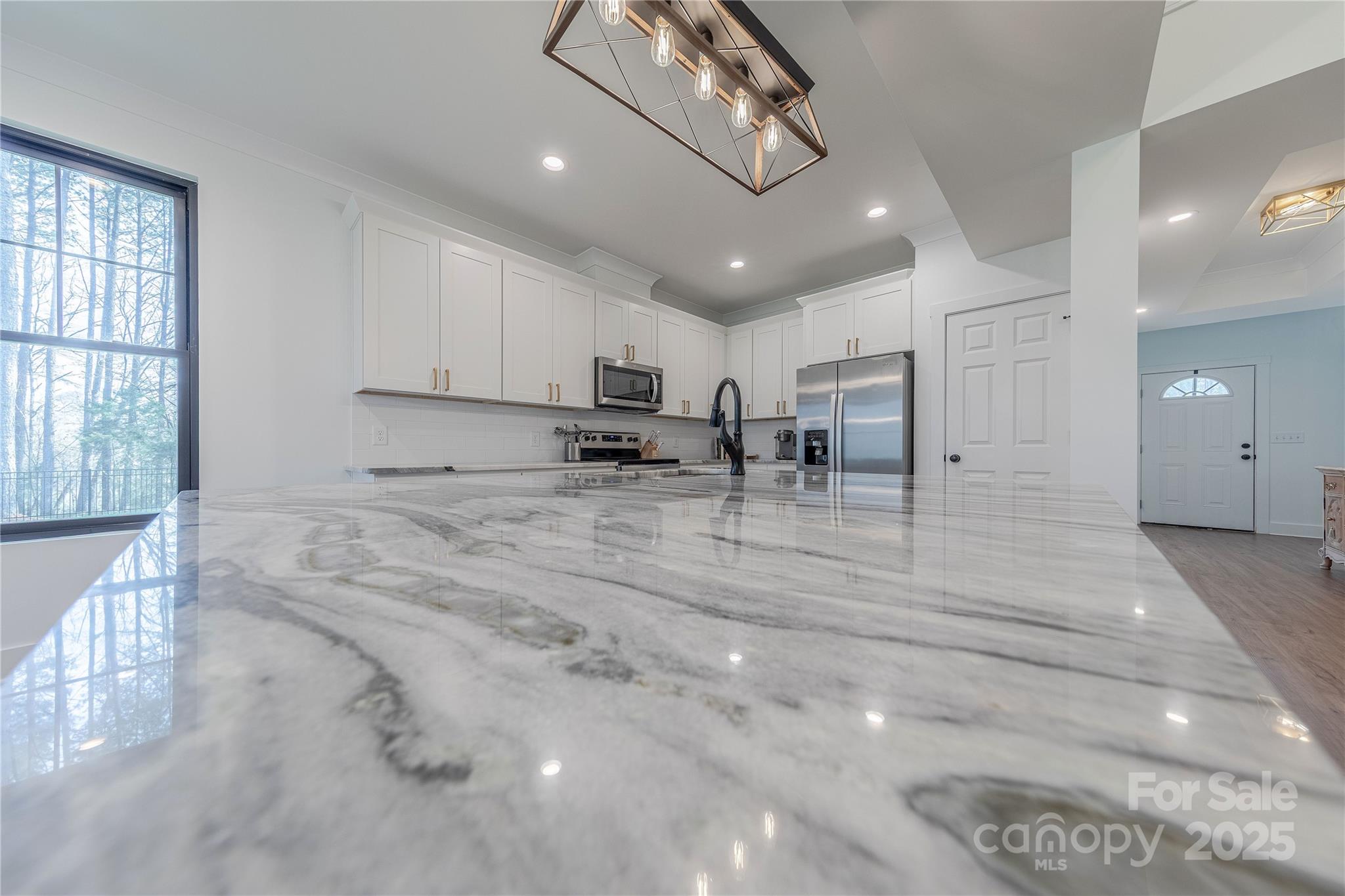 13625 Buster Road Stanfield, NC 28163 - Photo 13 of 43 a view of kitchen with stainless steel appliances furniture a refrigerator and chandelier