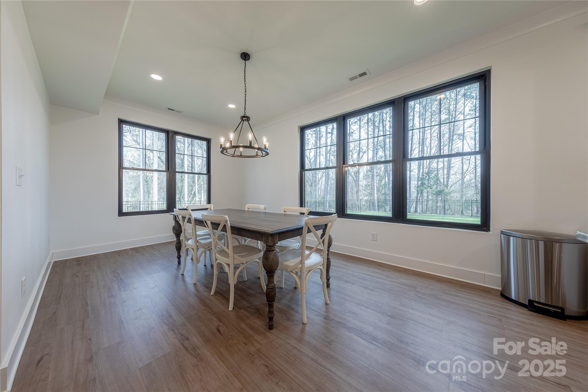 13625 Buster Road Stanfield, NC 28163 - Photo 14 of 43 a dining room with wooden floor a chandelier a wooden table and chairs