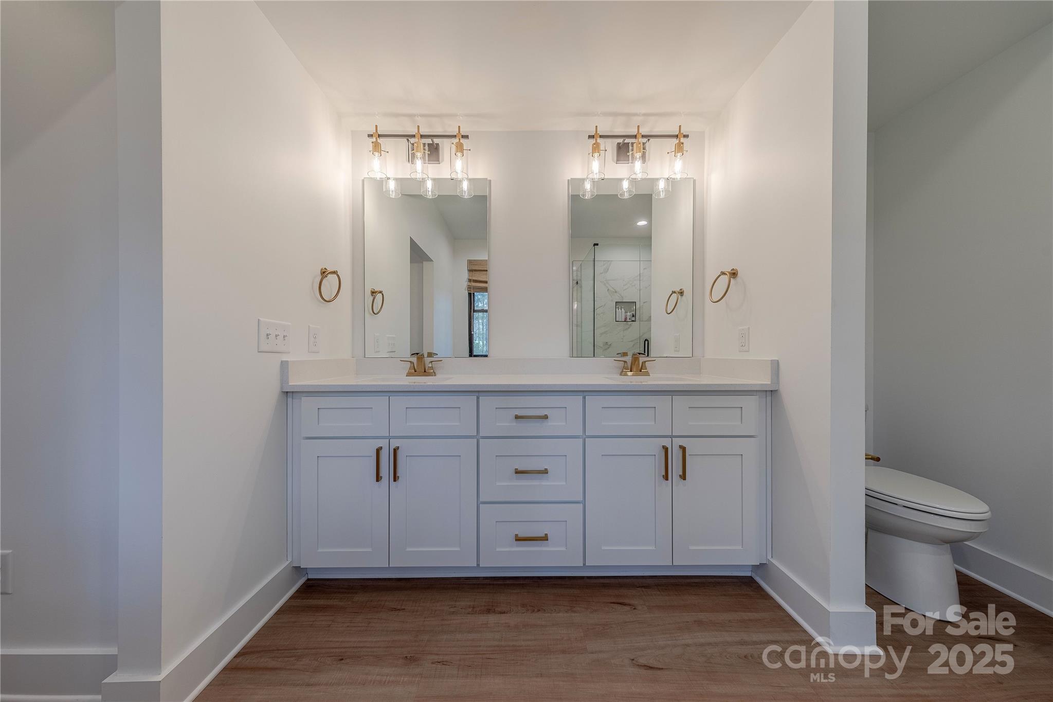 13625 Buster Road Stanfield, NC 28163 - Photo 23 of 43 a bathroom with a granite countertop sink a toilet and a mirror