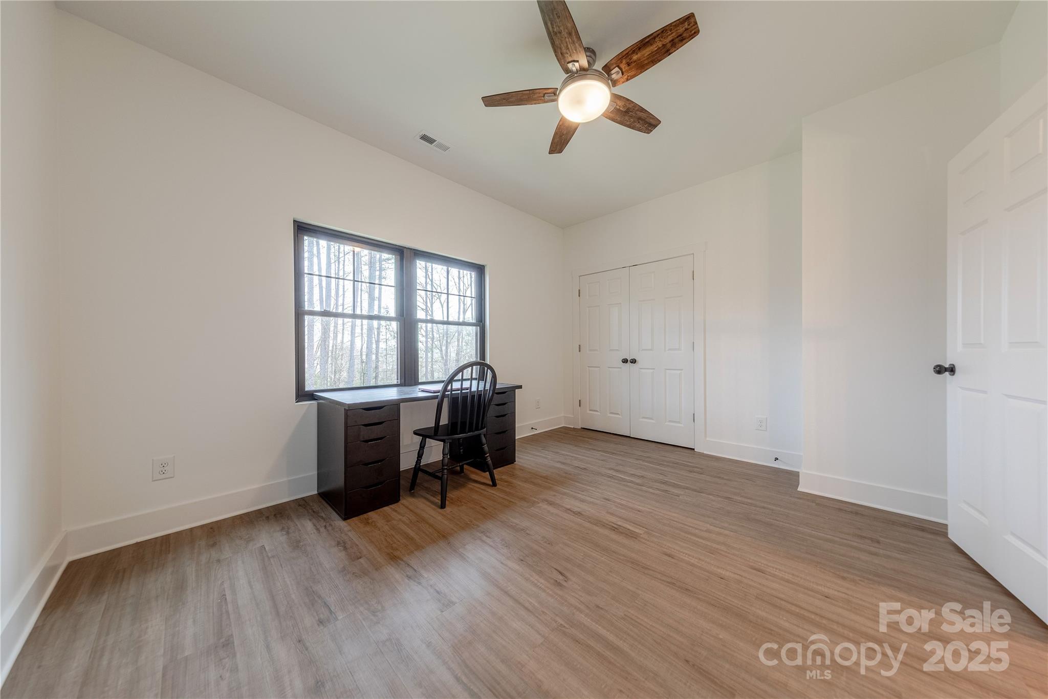13625 Buster Road Stanfield, NC 28163 - Photo 30 of 43 an empty room with a window and a ceiling fan