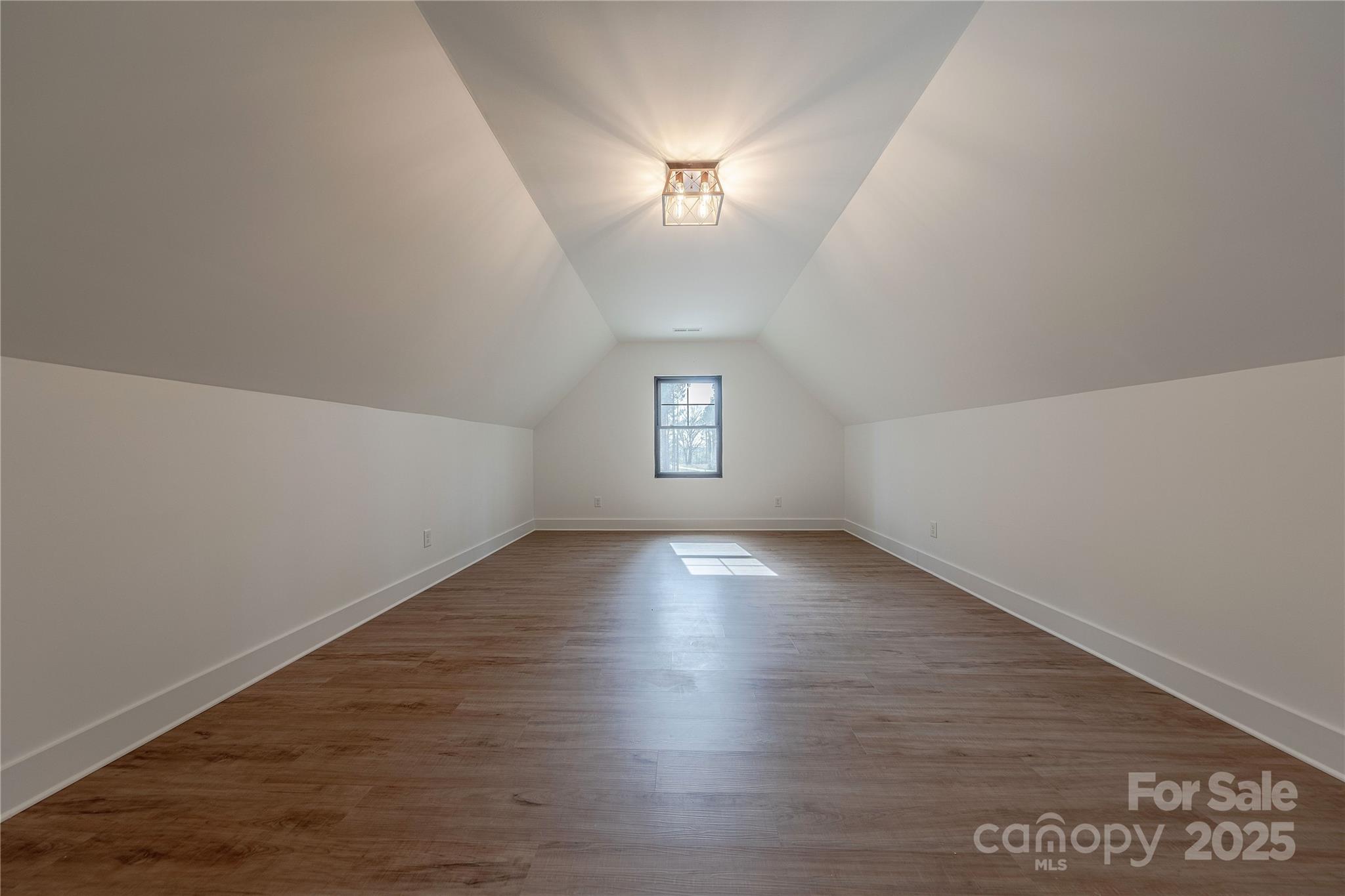 13625 Buster Road Stanfield, NC 28163 - Photo 31 of 43 an empty room with wooden floor and windows