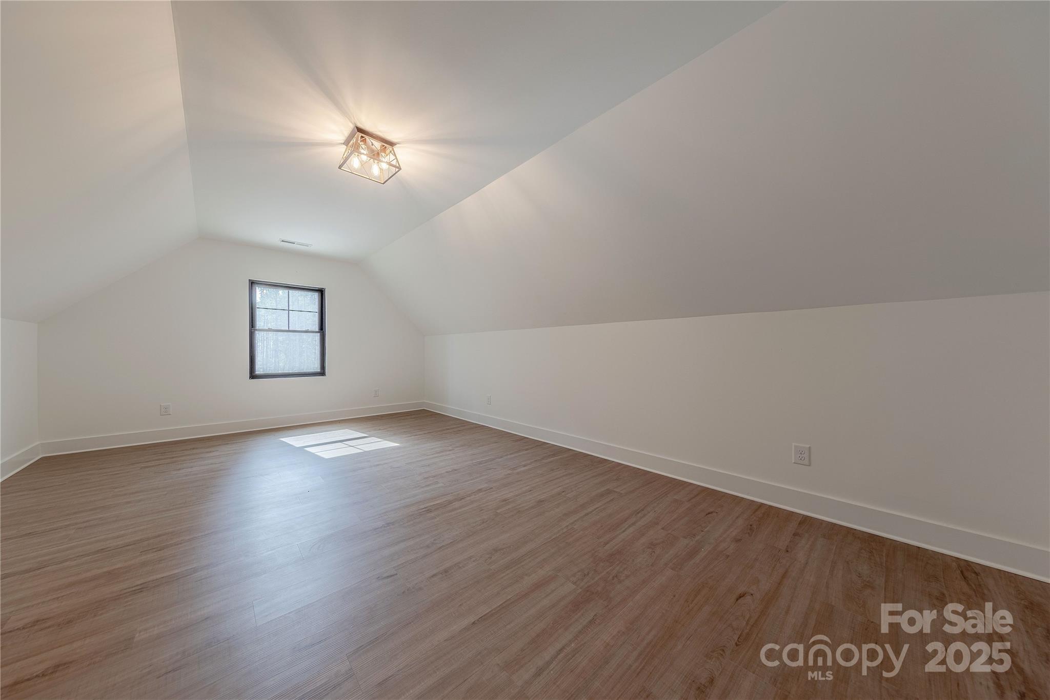 13625 Buster Road Stanfield, NC 28163 - Photo 32 of 43 an empty room with wooden floor and windows
