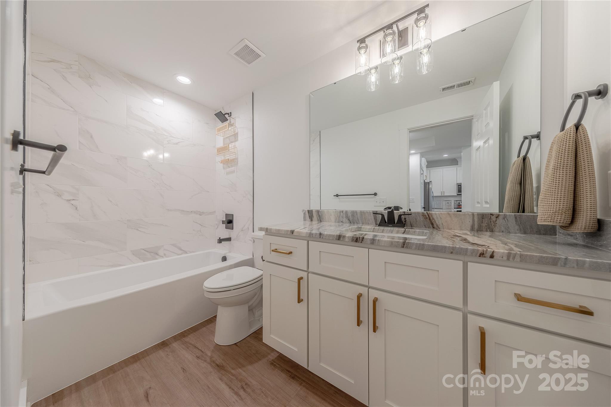 13625 Buster Road Stanfield, NC 28163 - Photo 34 of 43 a bathroom with a double vanity sink toilet mirror and bathtub