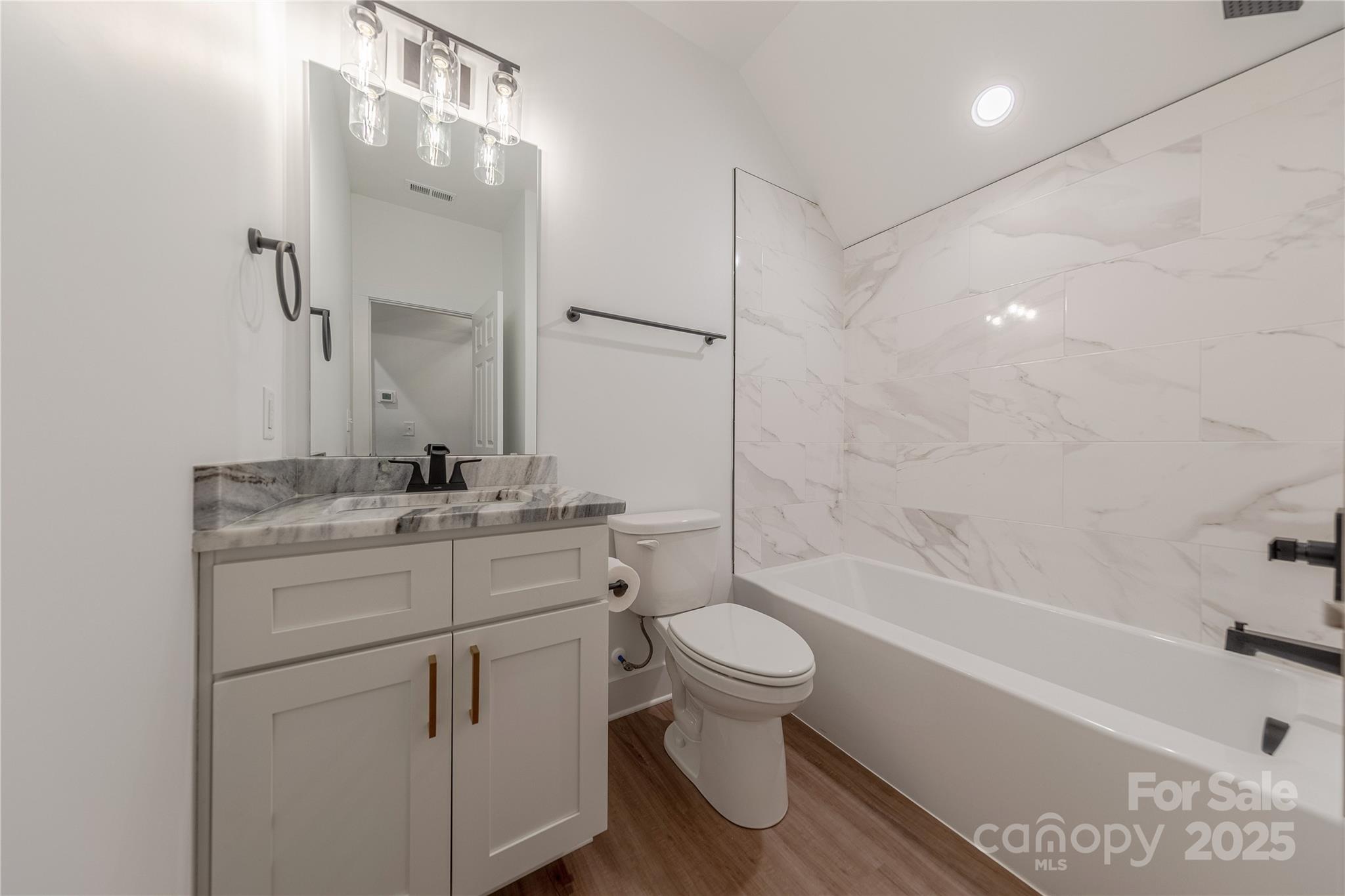 13625 Buster Road Stanfield, NC 28163 - Photo 37 of 43 a bathroom with a sink toilet a bathtub and a vanity