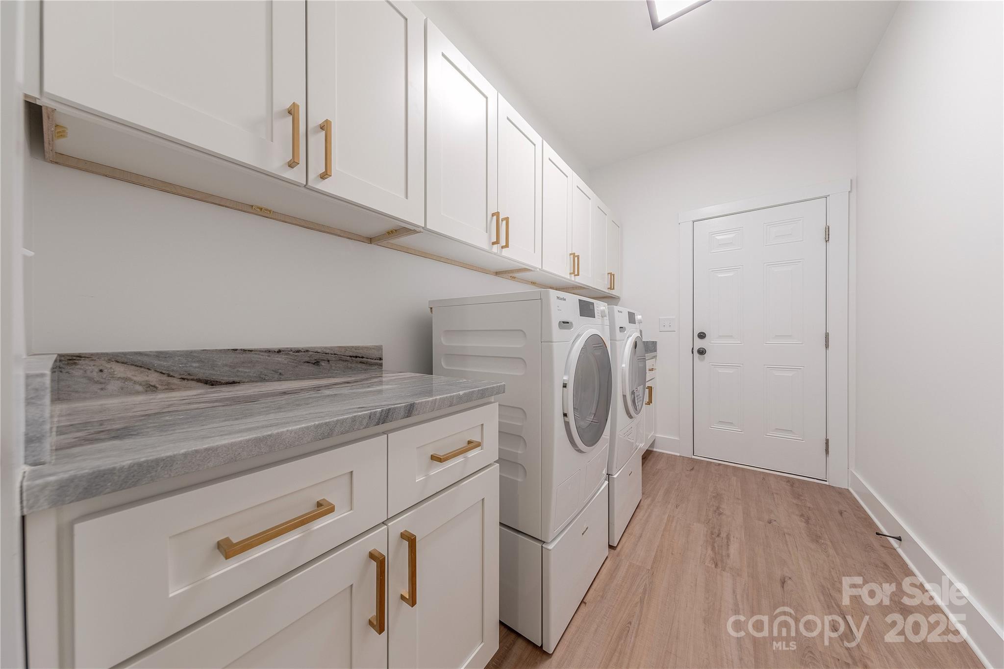 13625 Buster Road Stanfield, NC 28163 - Photo 38 of 43 a view of a storage and utility room with washer and dryer