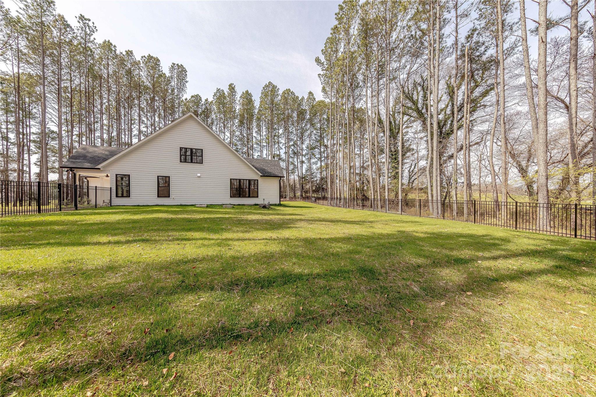 13625 Buster Road Stanfield, NC 28163 - Photo 41 of 43 a view of a house with a big yard and large trees