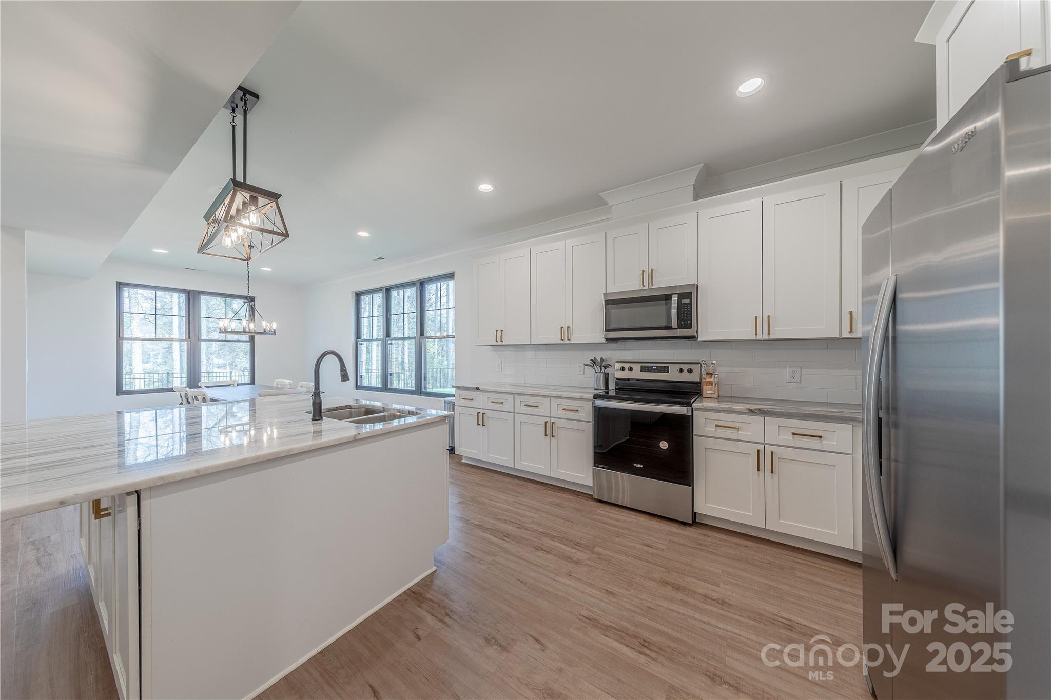 13625 Buster Road Stanfield, NC 28163 - Photo 9 of 43 a kitchen with granite countertop white cabinets and stainless steel appliances