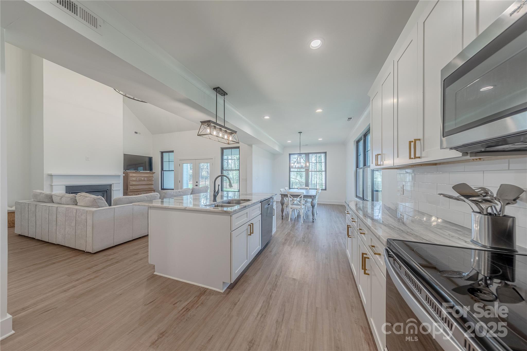 13625 Buster Road Stanfield, NC 28163 - Photo 10 of 43 a kitchen with stainless steel appliances granite countertop a lot of cabinets and wooden floor