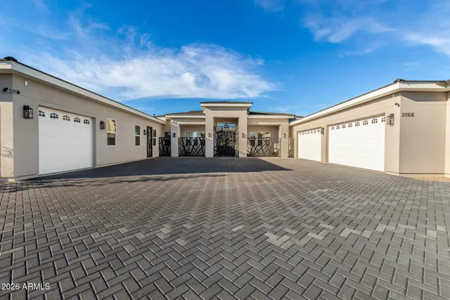 a dining hall with stainless steel appliances kitchen island granite countertop a table and chairs in it